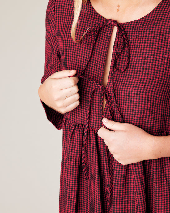 model wears red and black gingham linen willow dress