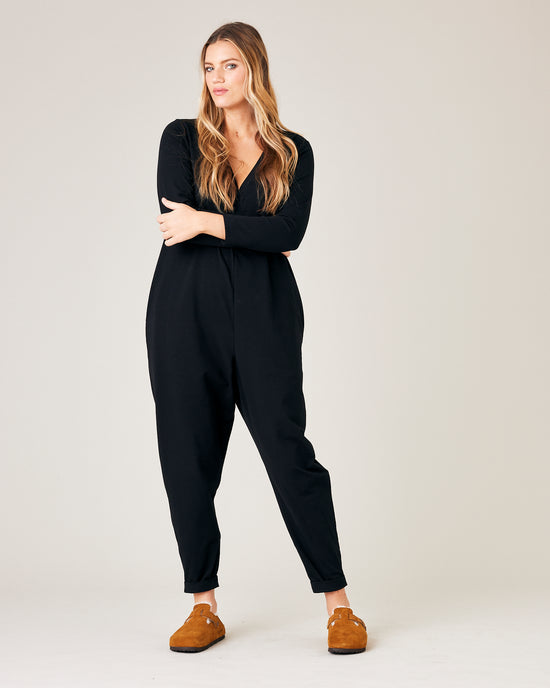 model wears black jersey milly jumpsuit