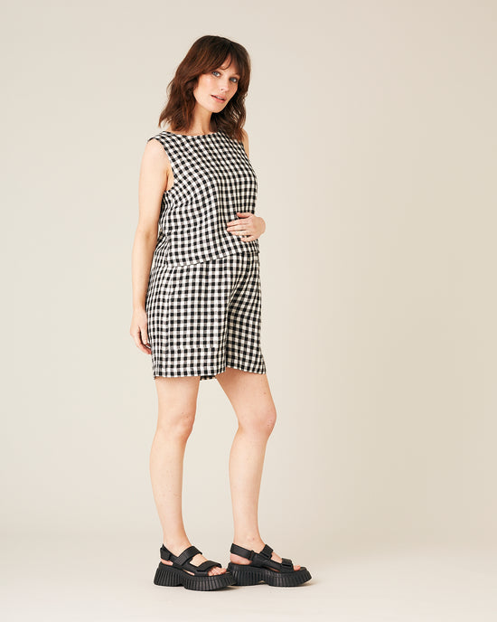 pregnant model wears black and white gingham linen esme top