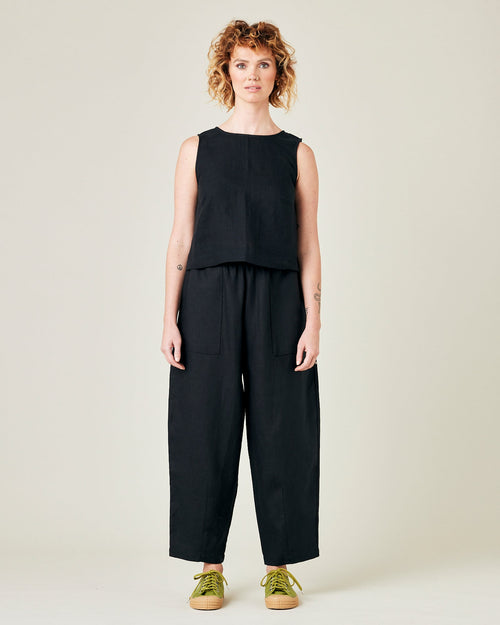 model wears longer length black linen huxley trousers