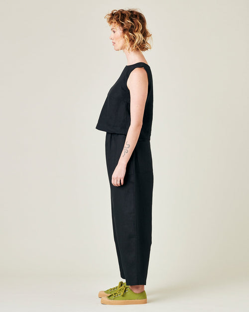 model wears longer length black linen huxley trousers