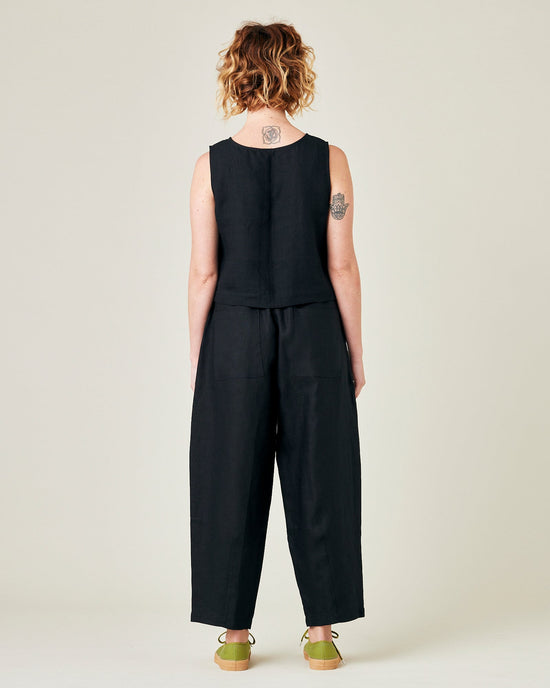 model wears black linen huxley trousers