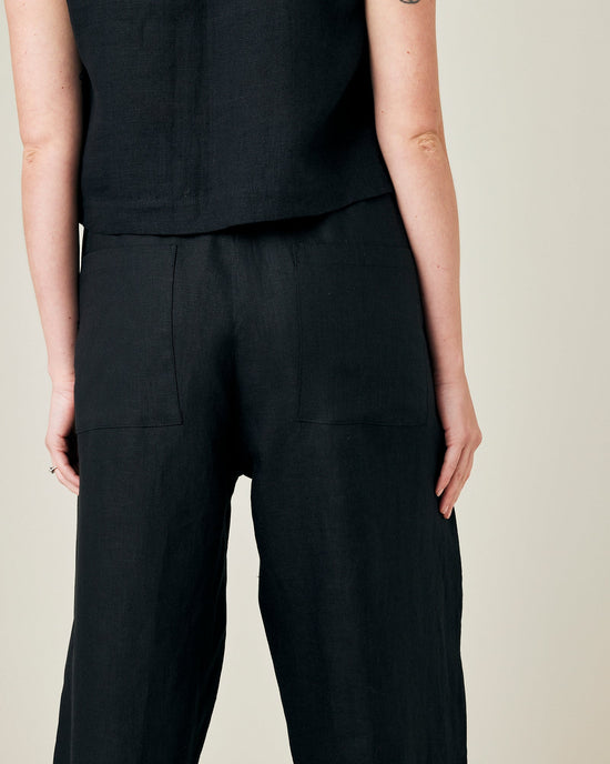 model wears black linen huxley trousers