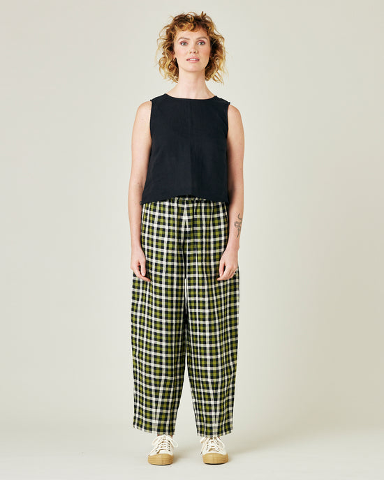 model wears olive black and ecru checked huxley trousers