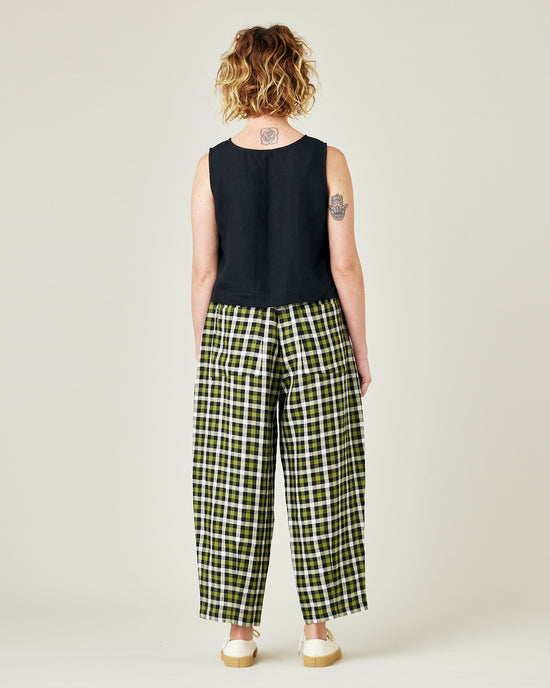 model wears olive black and ecru checked huxley trousers