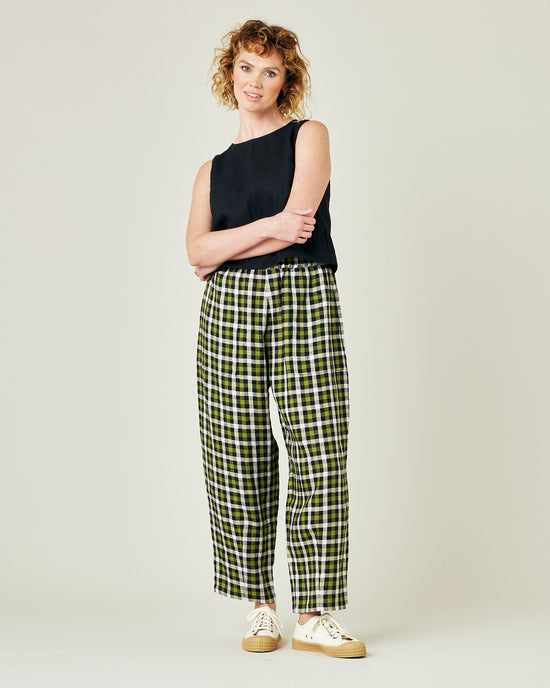 model wears olive black and ecru checked huxley trousers