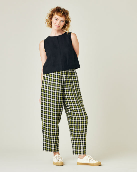 model wears olive black and ecru checked huxley trousers