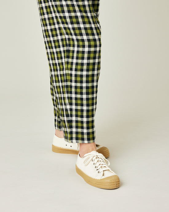 model wears olive black and ecru checked huxley trousers