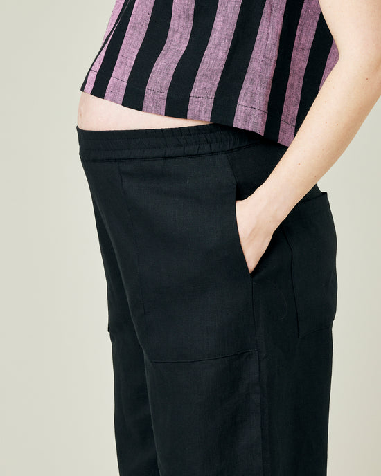 pregnant model wears black huxley linen trousers