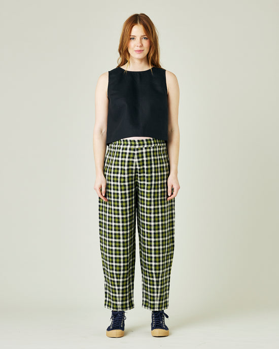 pregnant model wears olive black and ecru checked huxley trousers