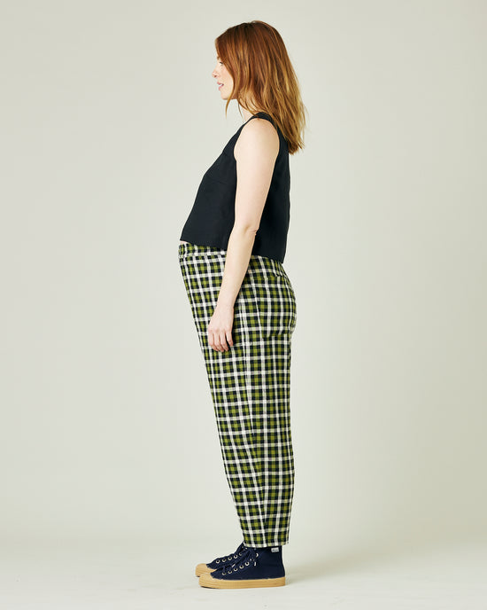 pregnant model wears olive black and ecru checked huxley trousers