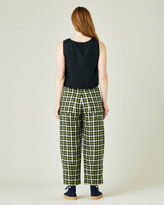 pregnant model wears olive black and ecru checked huxley trousers