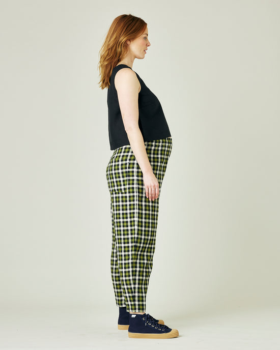 pregnant model wears olive black and ecru checked huxley trousers