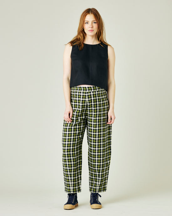 pregnant model wears olive black and ecru checked huxley trousers