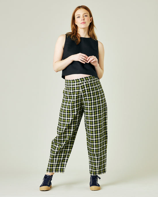 pregnant model wears olive black and ecru checked huxley trousers