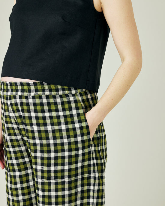 pregnant model wears olive black and ecru checked huxley trousers