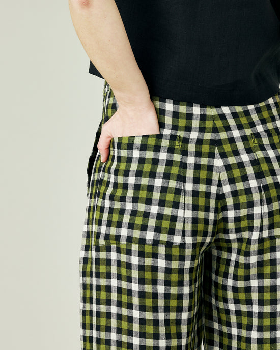 pregnant model wears olive black and ecru checked huxley trousers