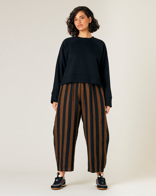 model wears rust stripe linen mabel trousers