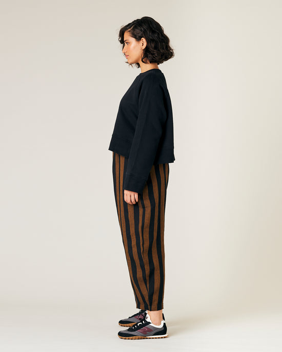 model wears rust stripe linen mabel trousers