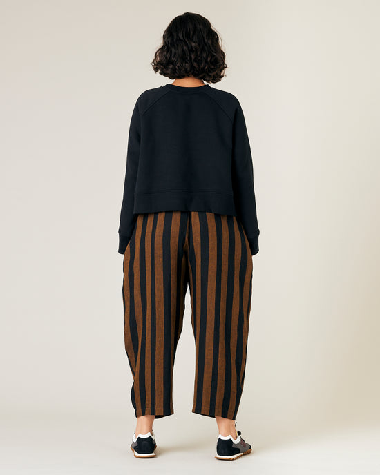 model wears rust stripe linen mabel trousers