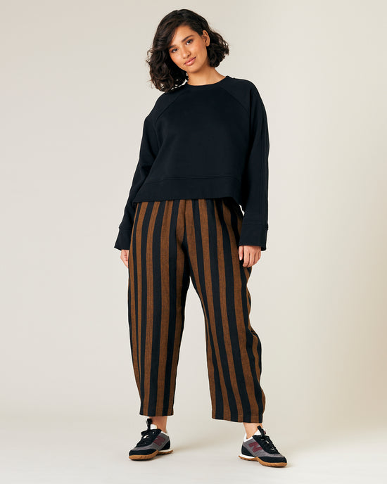 model wears rust stripe linen mabel trousers