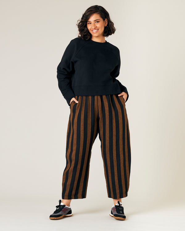 model wears rust stripe linen mabel trousers