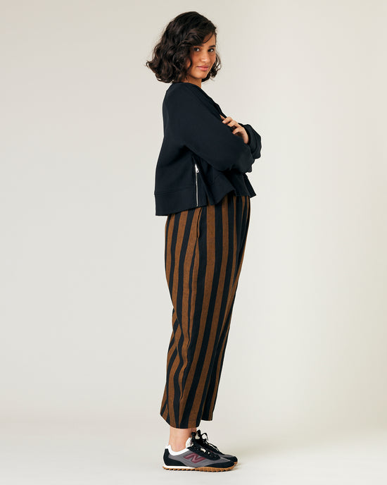 model wears rust stripe linen mabel trousers