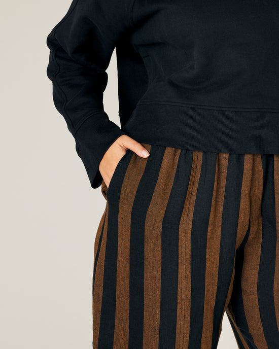 model wears rust stripe linen mabel trousers