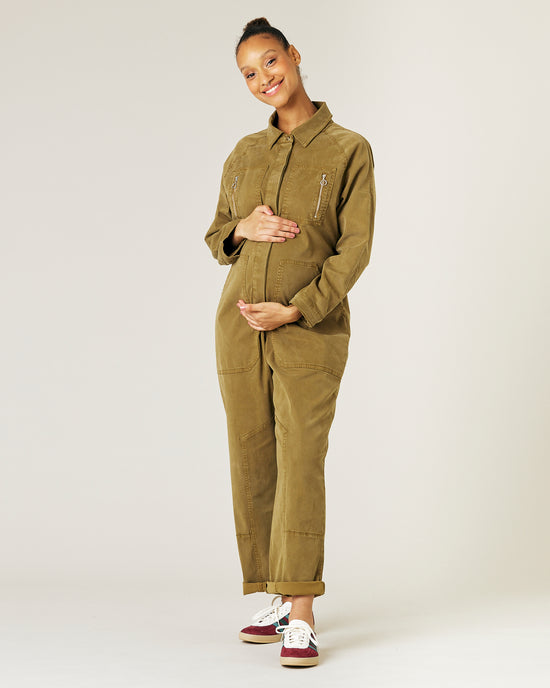 pregnant model wears nut green hallie jumpsuit