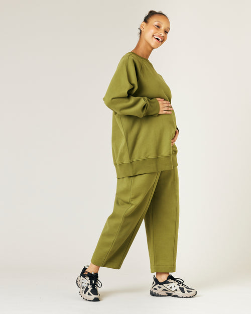 pregnant model wears avocado fleece jersey hugh jumper