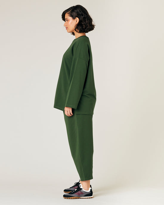 model wears kombu green jersey huxley trousers