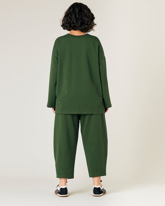 model wears kombu green jersey huxley trousers