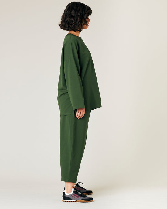 model wears kombu green jersey huxley trousers