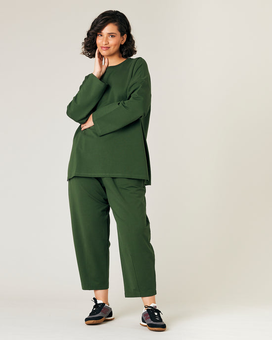 model wears kombu green jersey huxley trousers