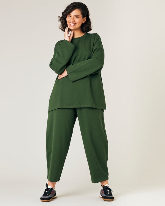 model wears kombu green jersey huxley trousers