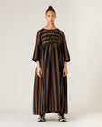 pregnant  model wears rust stripe willow linen dress