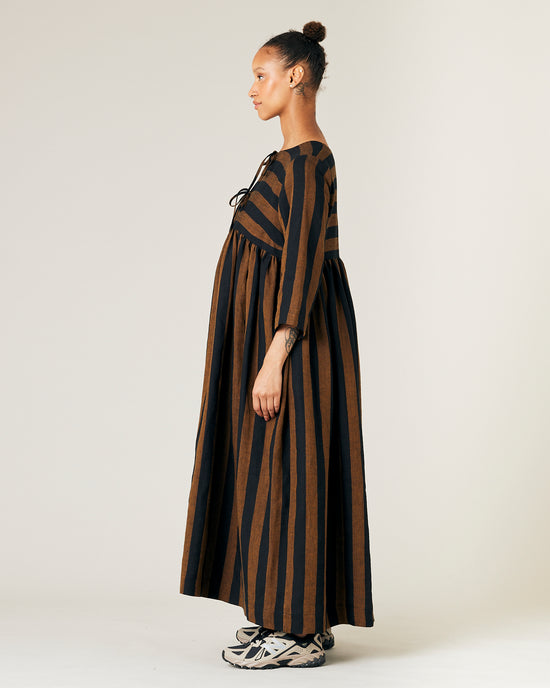 pregnant model wears rust stripe willow linen dress