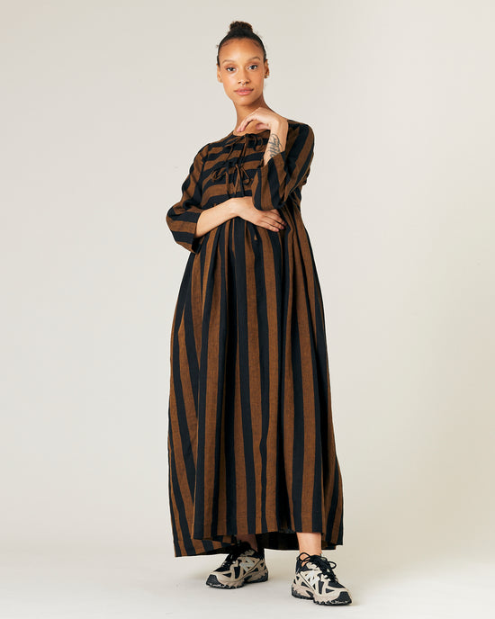 pregnant  model wears rust stripe willow linen dress