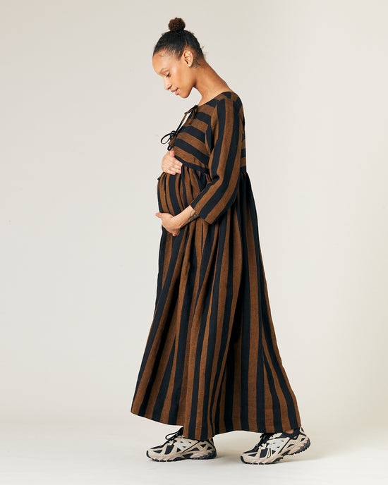 pregnant  model wears rust stripe willow linen dress