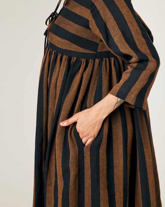 pregnant  model wears rust stripe willow linen dress