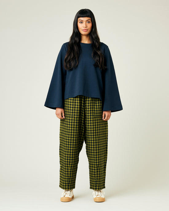 model wears green gingham huxley trousers