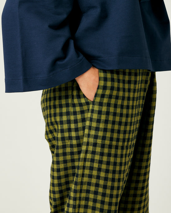 model wears green gingham huxley trousers