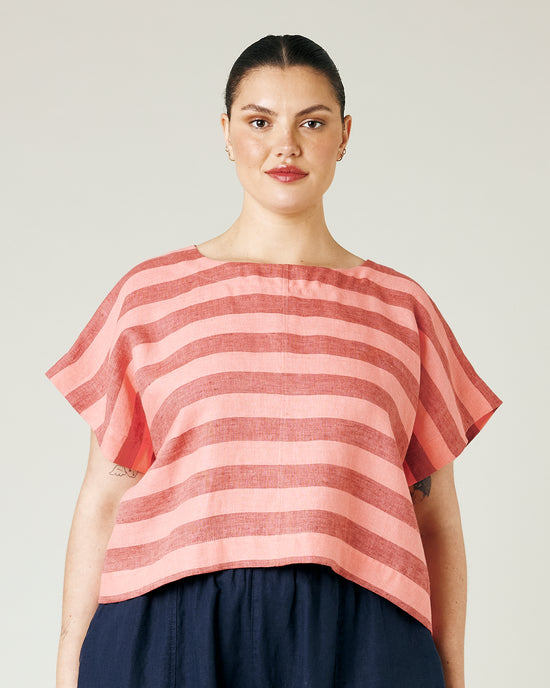 model wears blush stripe linen polly top