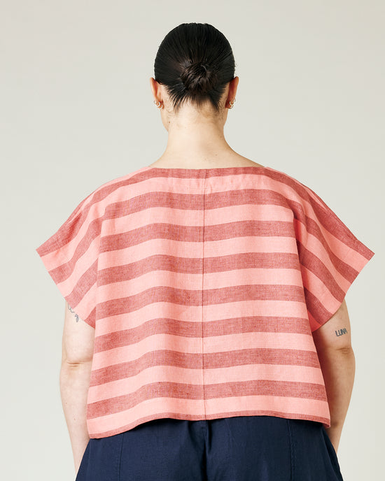 model wears blush stripe linen polly top