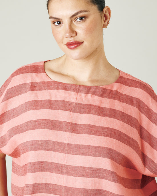 model wears blush stripe linen polly top