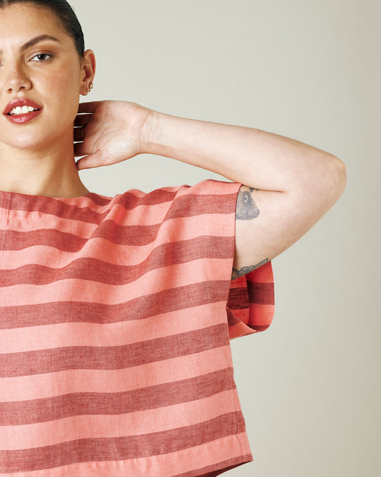 model wears blush stripe linen polly top