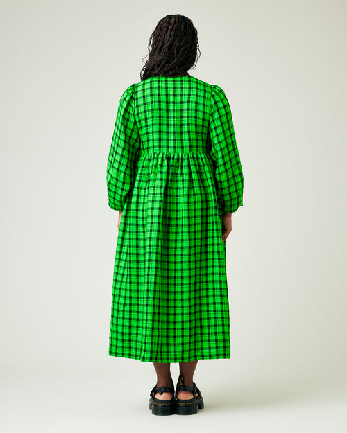 model wears green and black check linen isabel dress