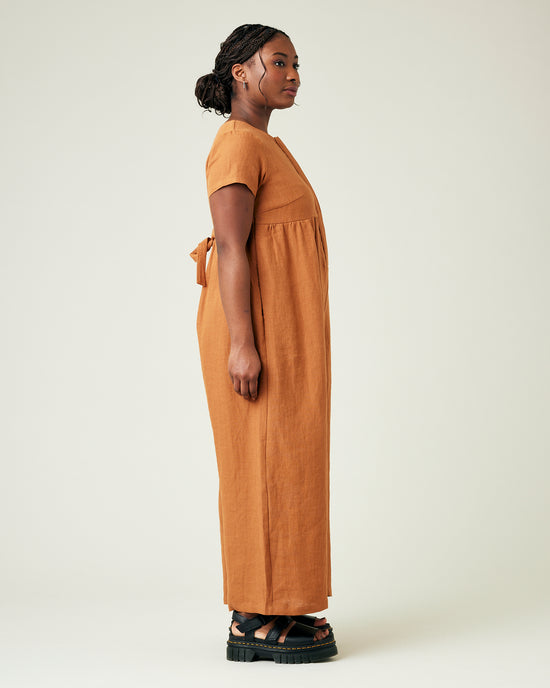 model wears rust linen sahara jumpsuit