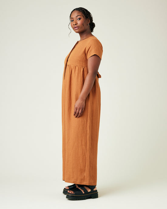 model wears rust linen sahara jumpsuit