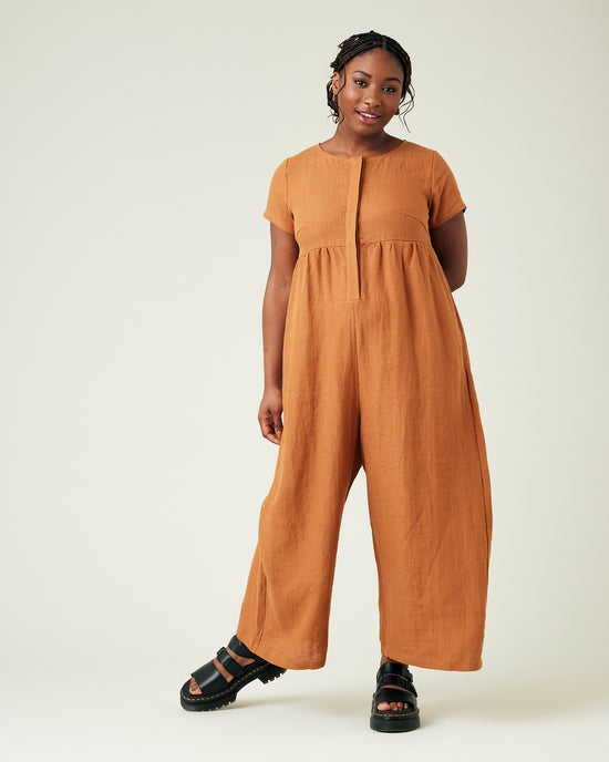 model wears rust linen sahara jumpsuit